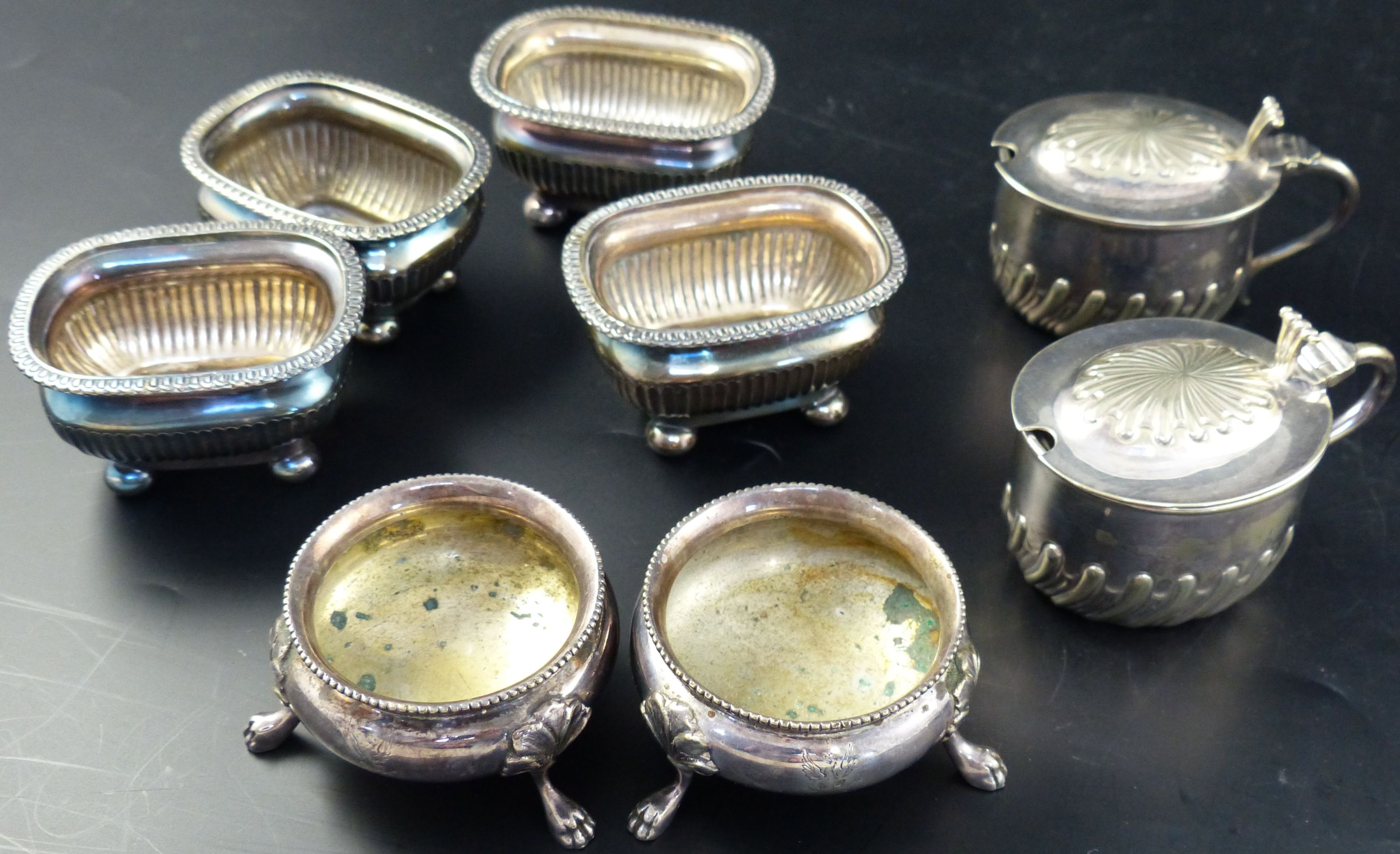 A group of assorted plated condiments, two silver condiments, a silver strainer two match tidies, etc.